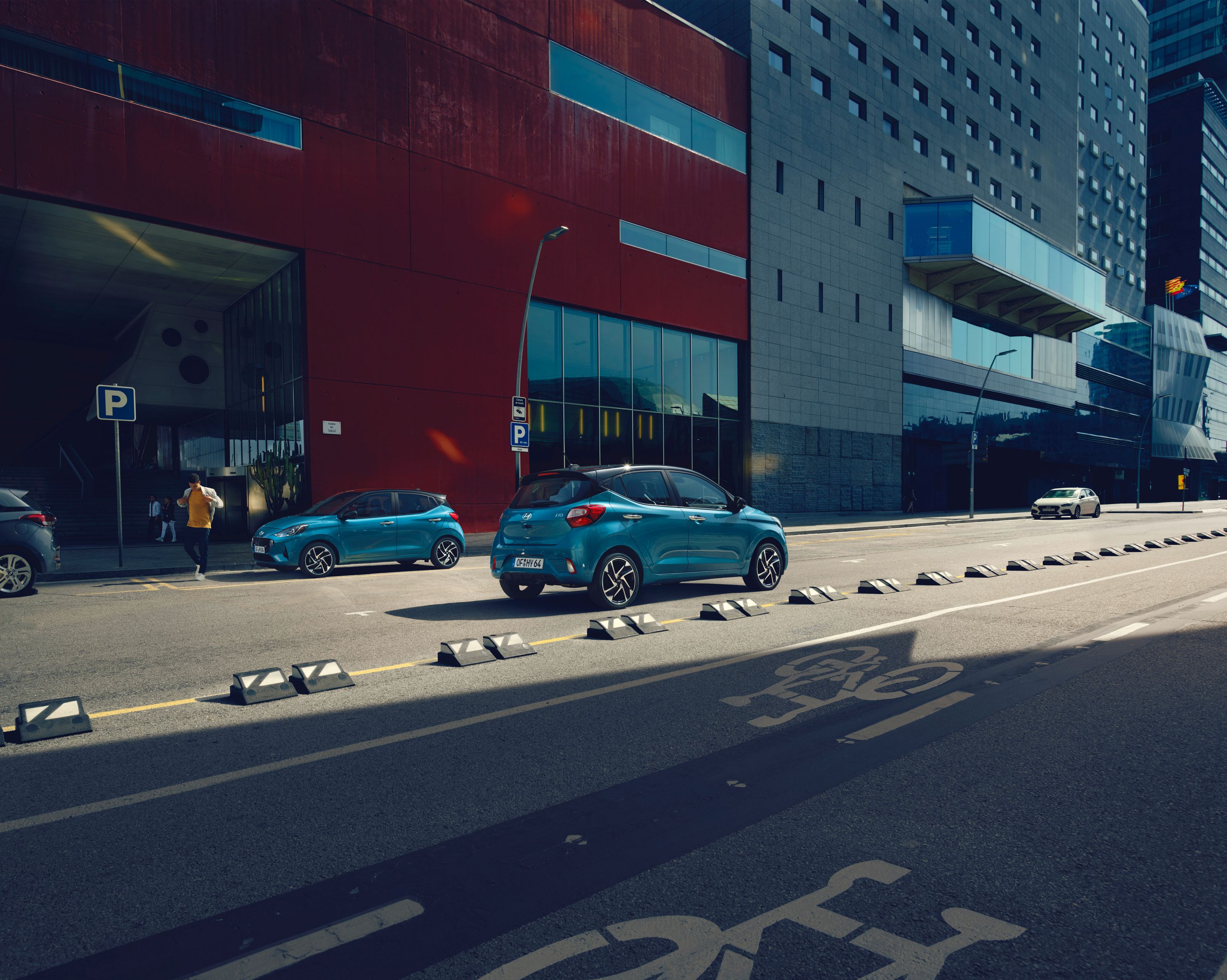 The Hyundai i10 in Aqua Turquoise Metallic driving through the city.