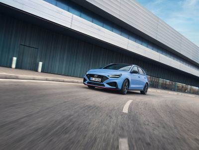 the new Hyundai i30 N performance hatchback in Performance Blue, slicing through a curve.