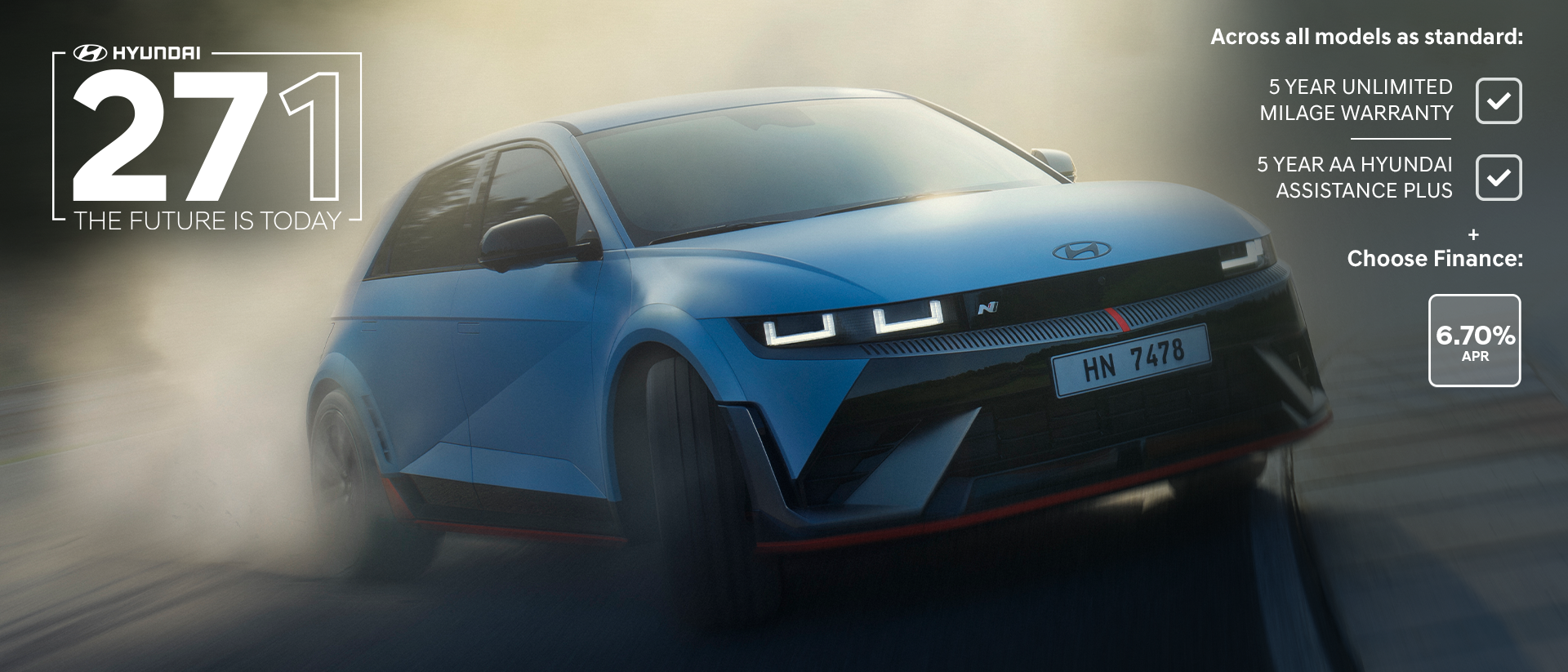 The all-electric Hyundai IONIQ 5 N drifting through a curve on a racetrack with smoking tyres.