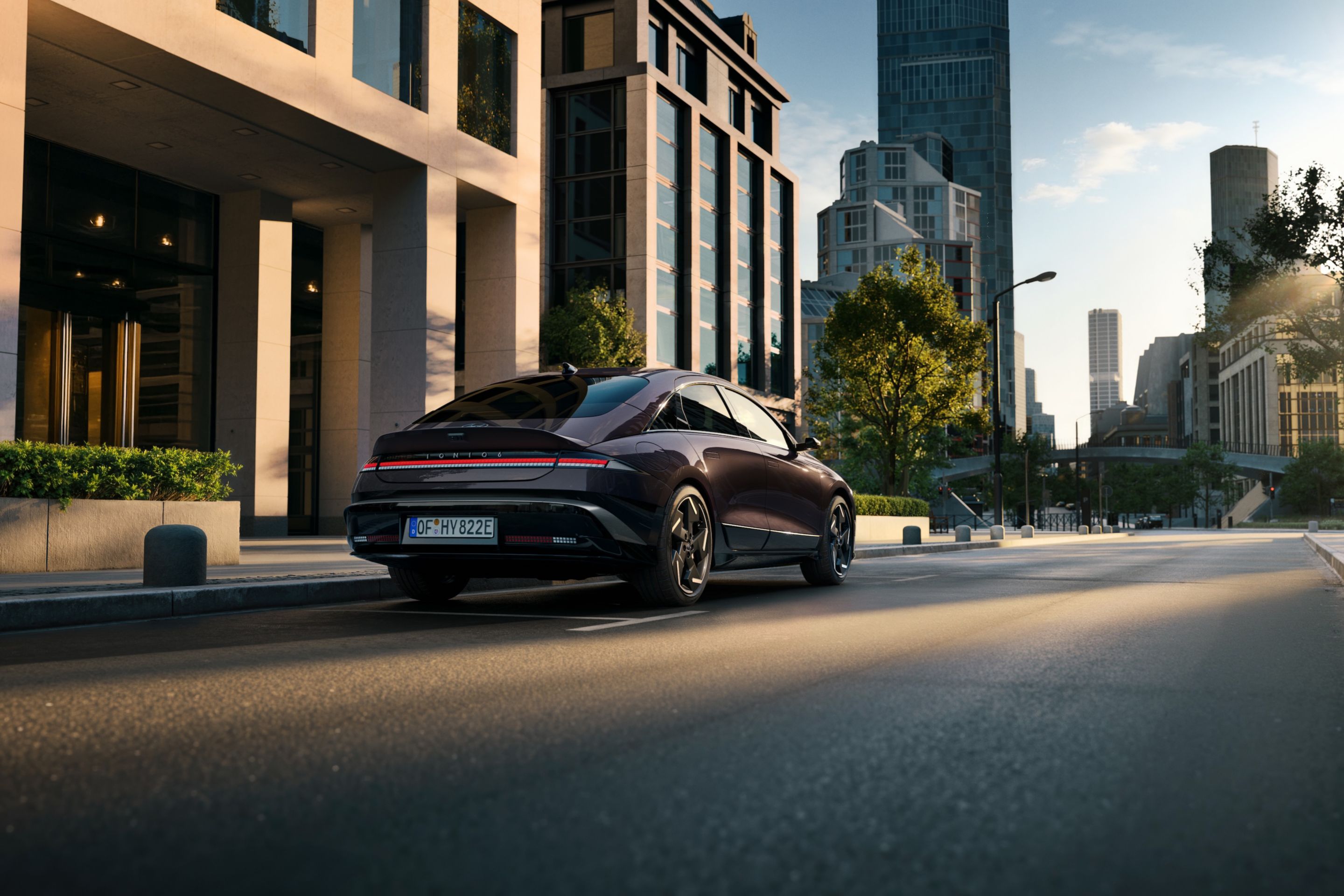 Hyundai IONIQ 6 electric sedan shown from the rear and side parked on a city street.