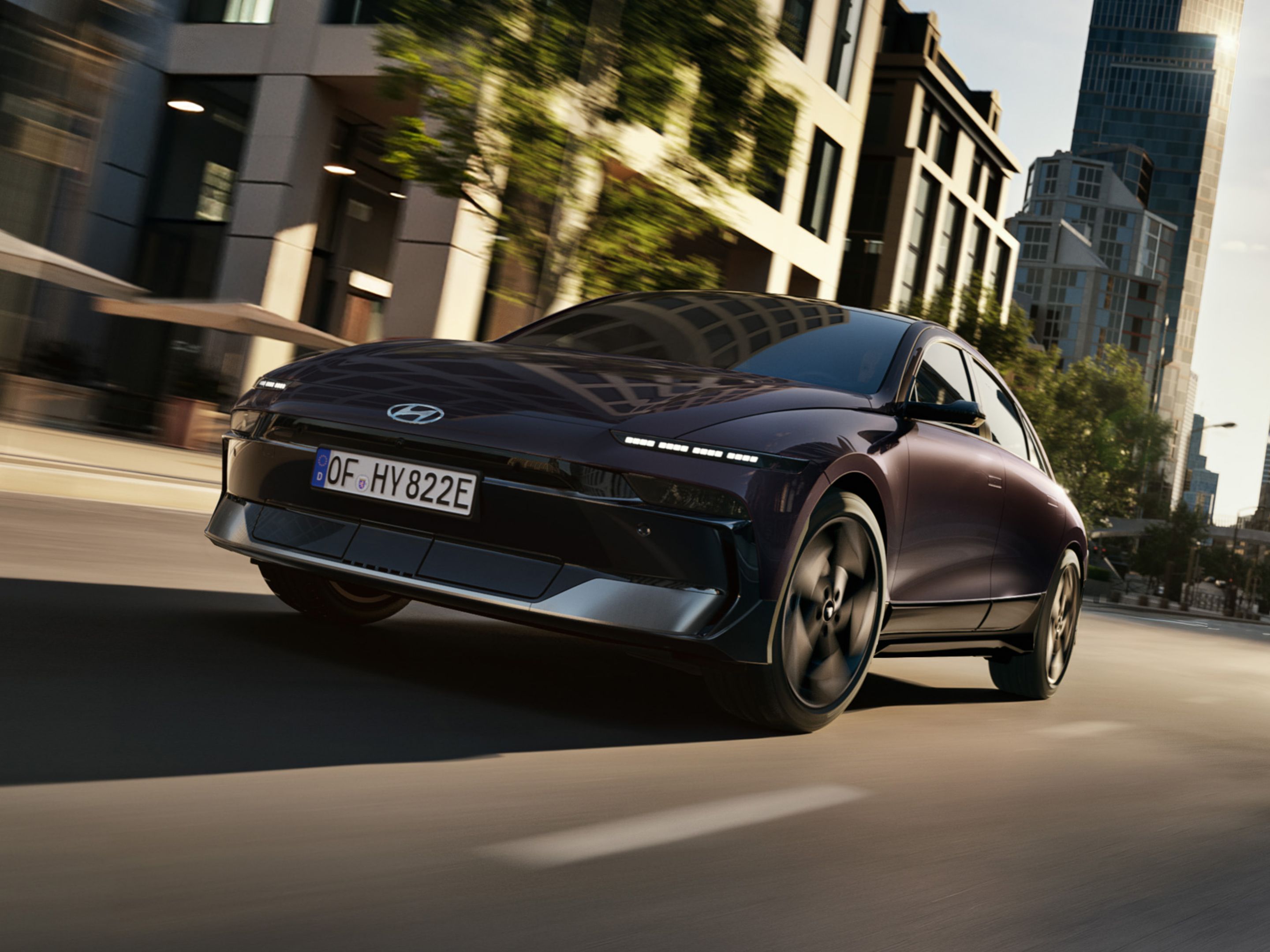 HYUNDAI IONIQ 6 in motion on a city street, captured from a low rear angle emphasizing speed, performance, and dynamic design.