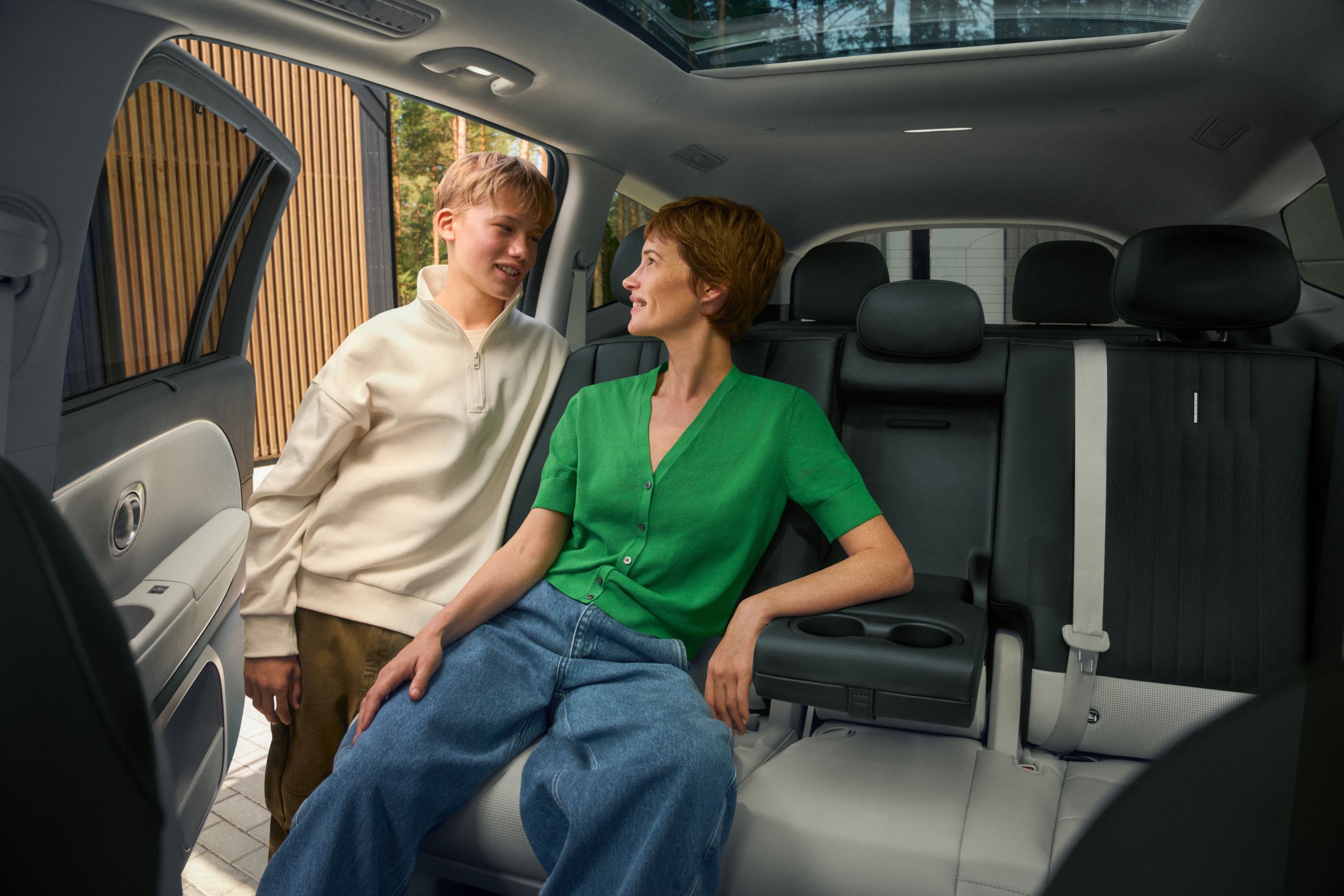 Spacious rear seating area in Hyundai IONIQ 9 with passenger and open cabin view