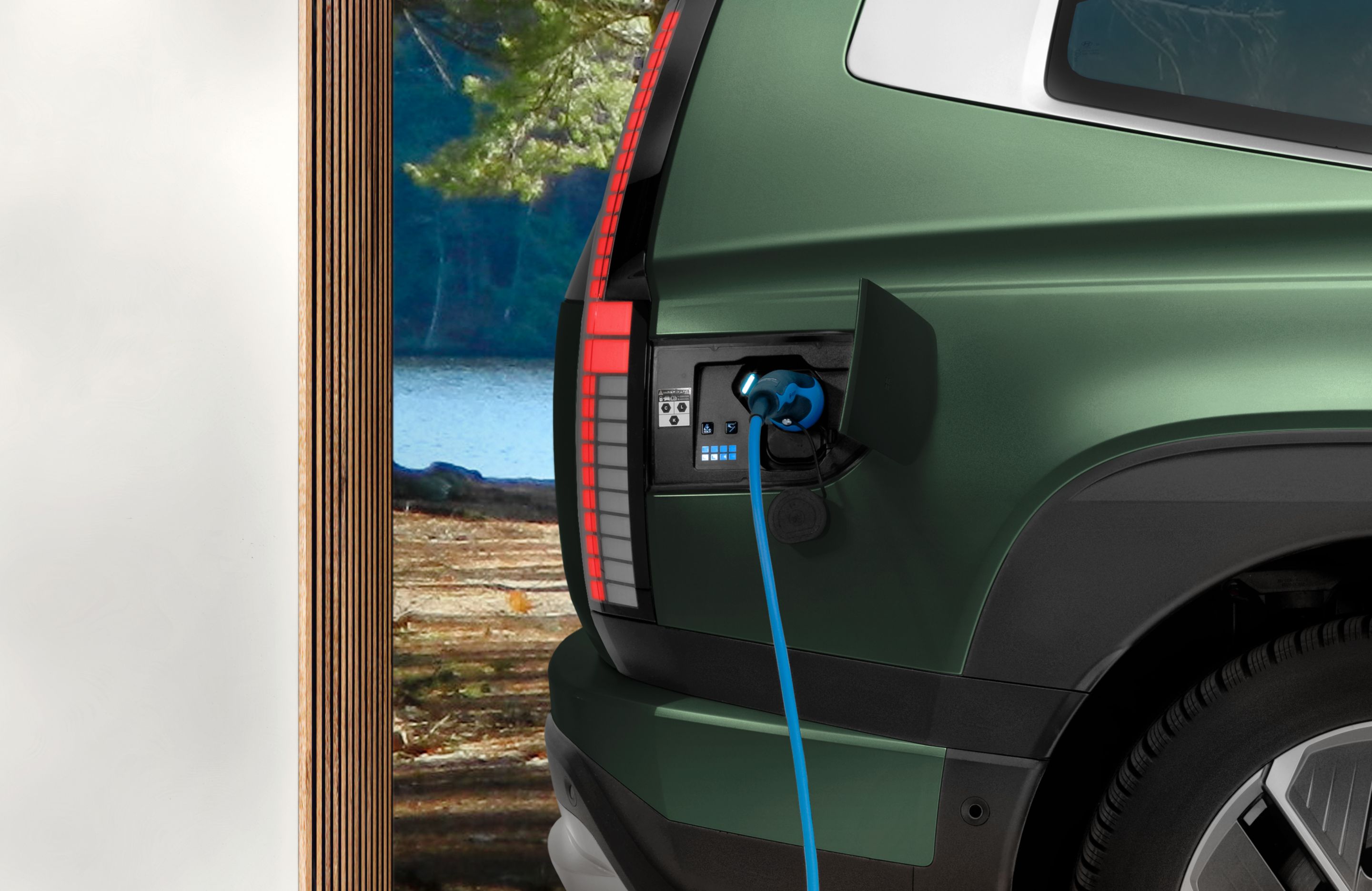 The open charging socket of Hyundai IONIQ 9 electric SUV with charging cable.