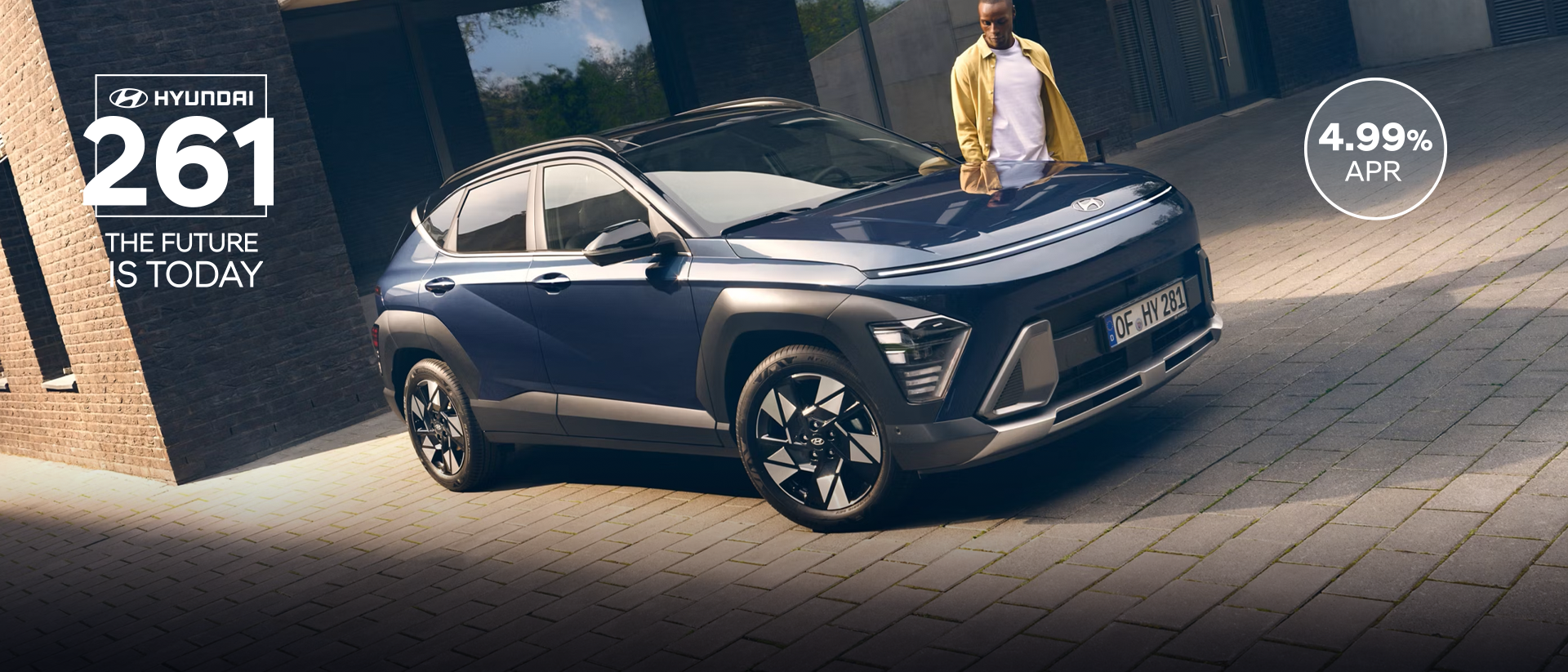 The all-new Hyundai KONA in blue parked next to a men with yellow shirt.