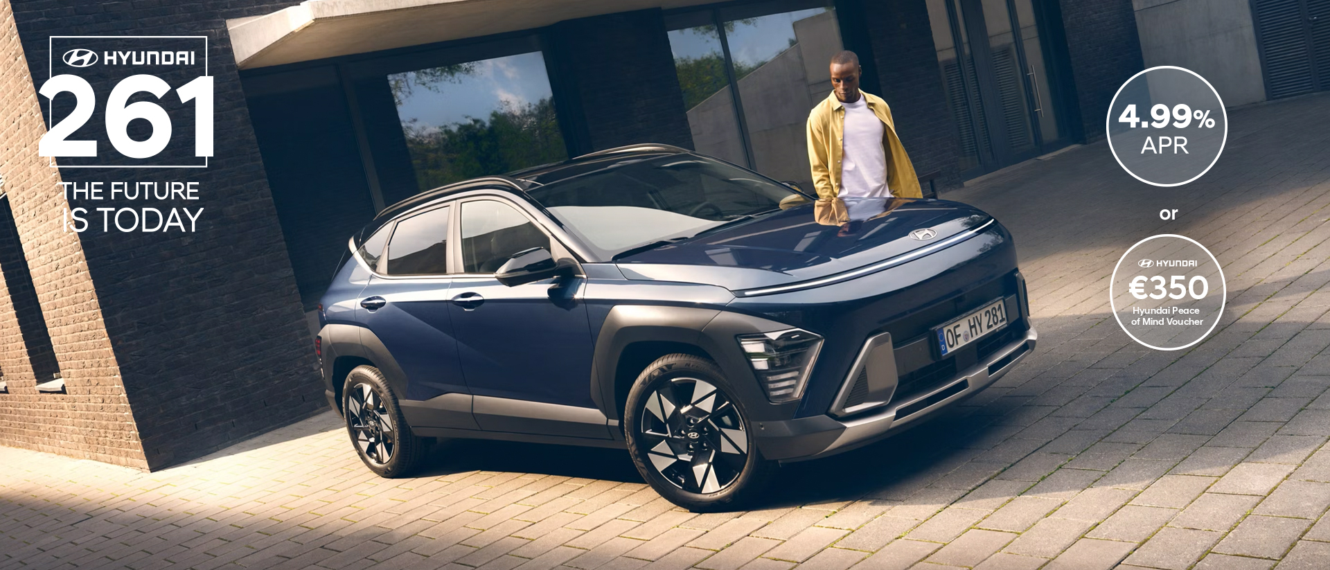 The all-new Hyundai KONA in blue parked next to a men with yellow shirt.