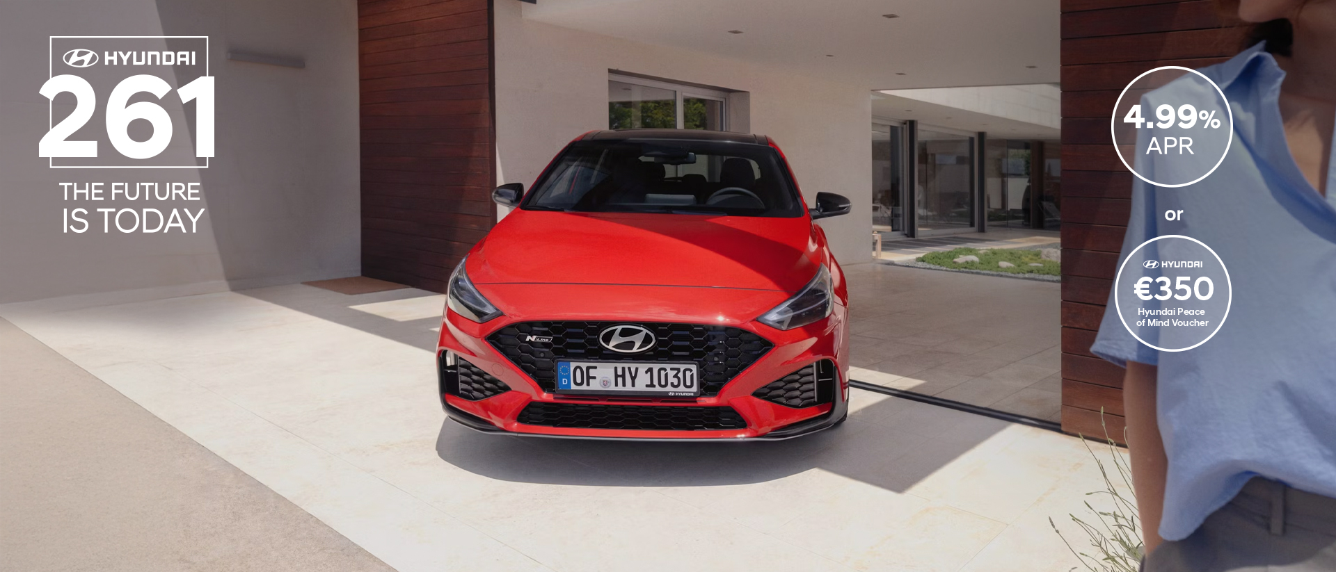 The new Hyundai i30 N Line in red parked in front of the house.