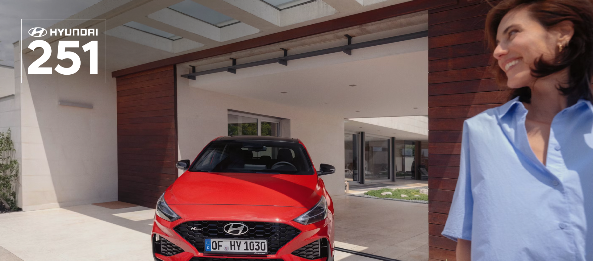 The new Hyundai i30 N Line in red parked in front of the house.