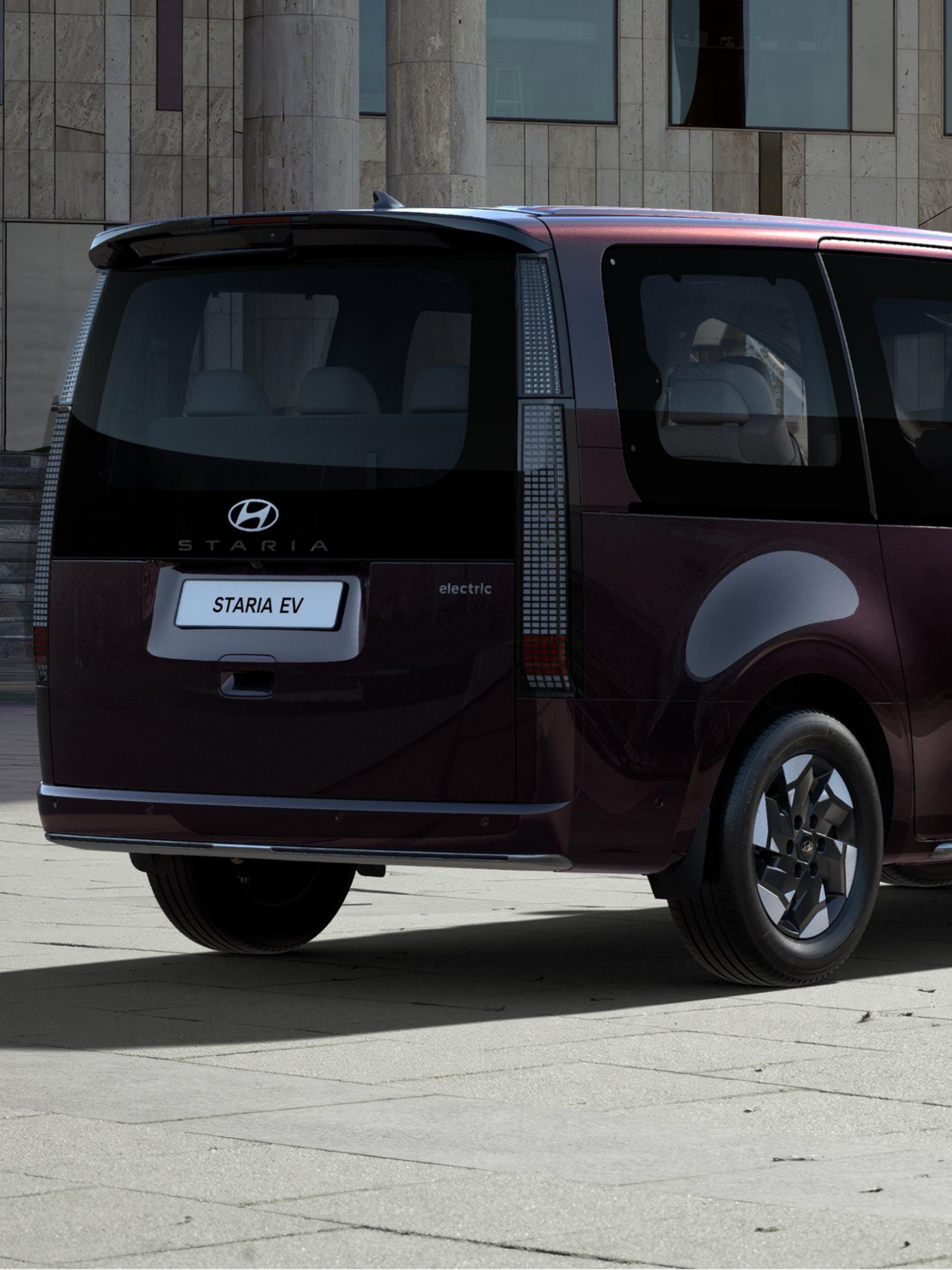 Rear three-quarter view of a parked Hyundai STARIA Electric.