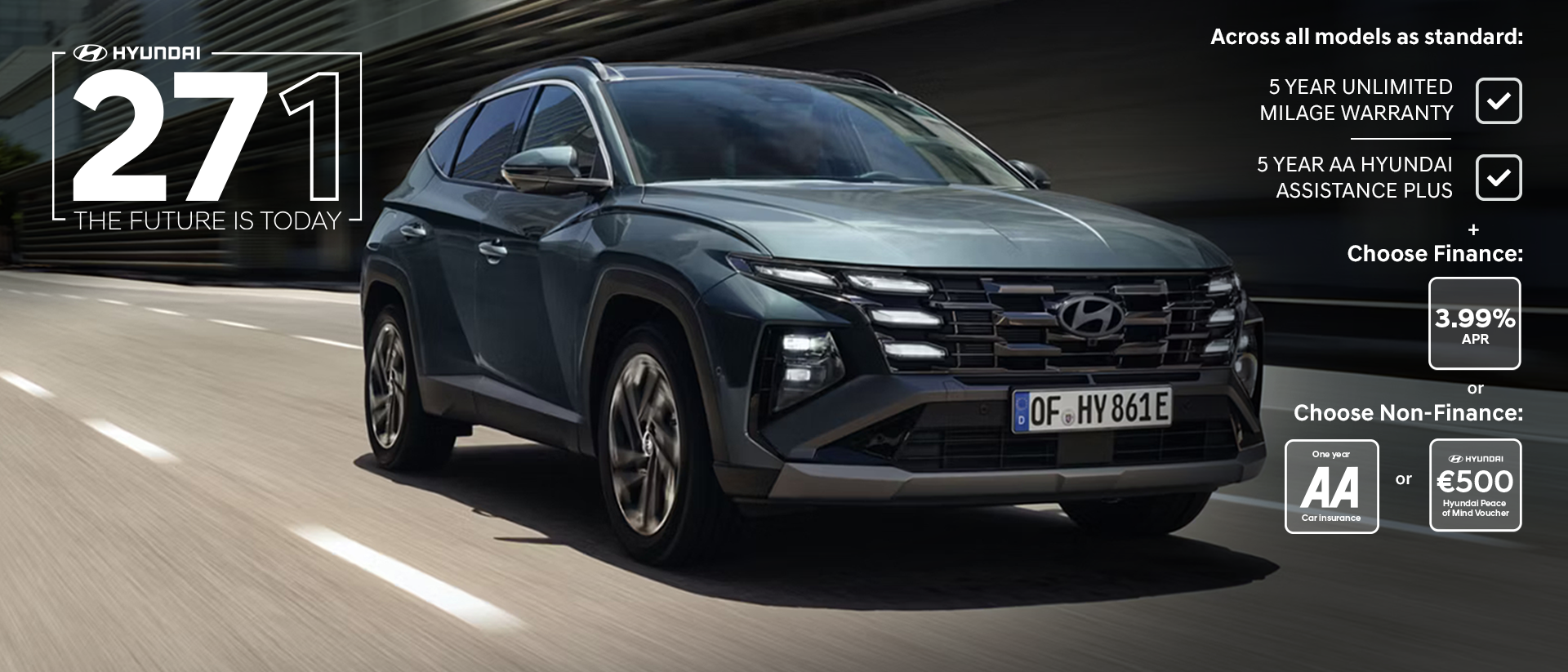 The Hyundai TUCSON Plug-in Hybrid driving down a city street with modern buildings visible.